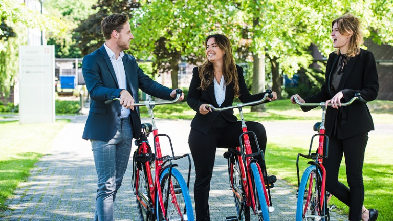 Students on a bike on campus