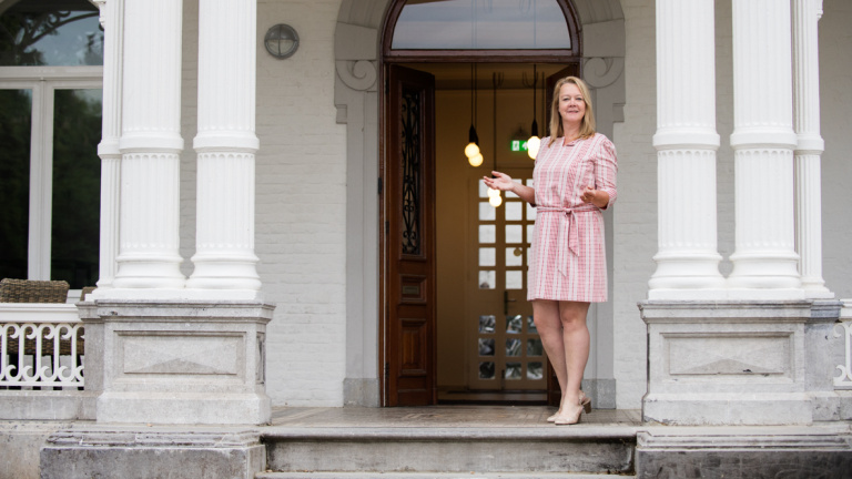 Binie Hermans standing in front of the Teaching Hotel