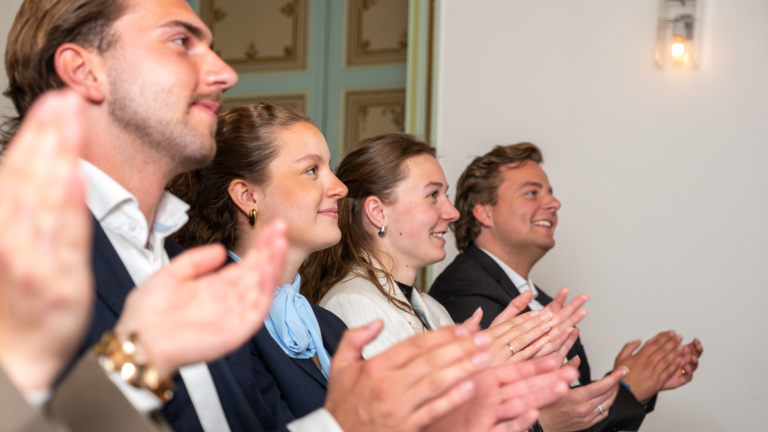 Student clapping in classroom.