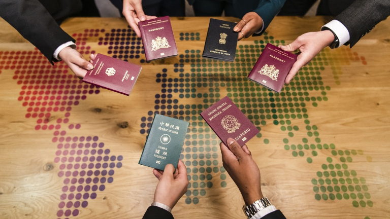 International students holding their passports over a table