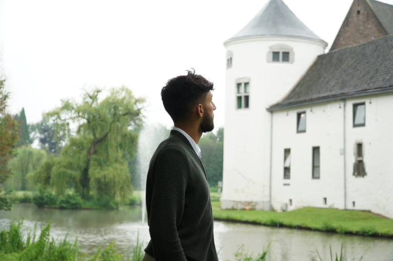 Jean Maroun looking at the Teaching Hotel outside near the water